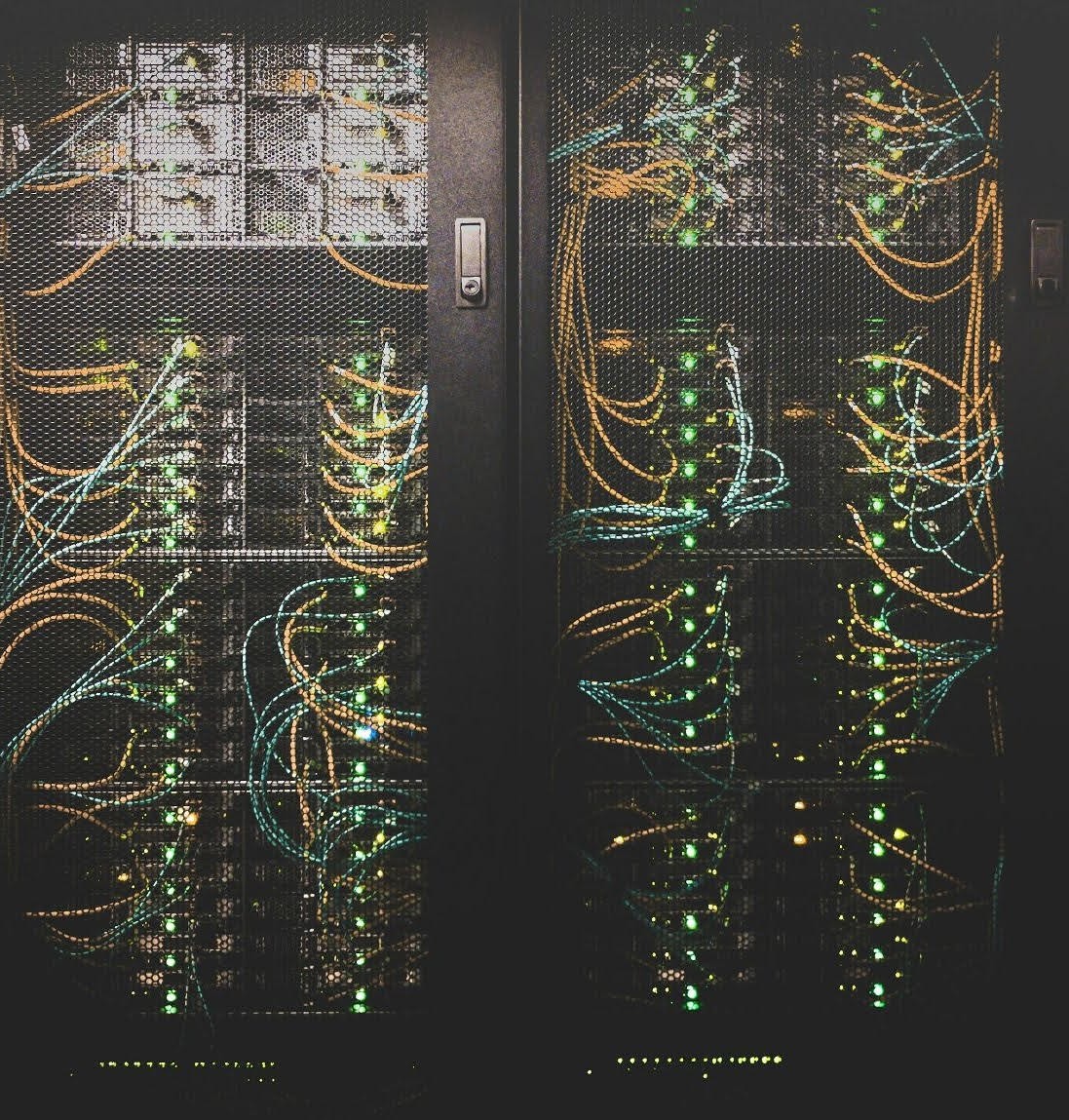 Photo of HPC server towers with colorful wires and lights lit up