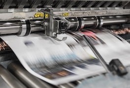 Image of a printer roller with a printed piece of paper in the process of being rolled out (printed)