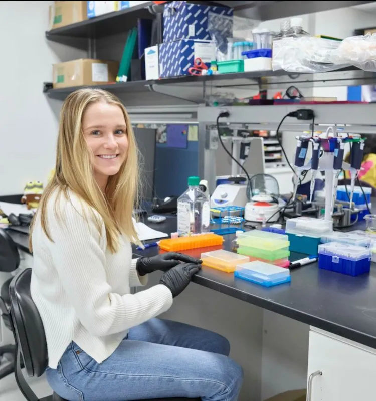 Undergraduate researcher seated at a lab desk